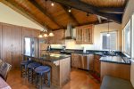 Enjoy bar stools at the kitchen counter while watching the master chef prepare dinner